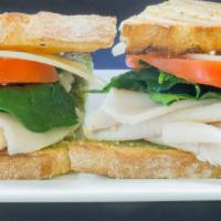 Turkey Panini · Turkey breast, pesto, spinach and tomato crowned with melted provolone cheese. Includes lett...