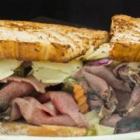 Roast Beef Panini · Roast beef, spicy giardiniera peppers, roasted green peppers and onions crowned with melted ...