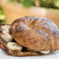 Banana Nutella · Sliced banana and Nutella between a panini-pressed croissant. Topped with powdered sugar and...