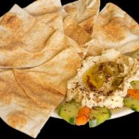 Hummus Plate · Hummus with olive oil and sumac served with carrots, cucumber slices and pita triangles.
