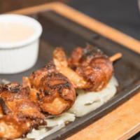 Concan Shrimp · Five jumbo gulf shrimp stuffed with smoked Gouda cheese and Anaheim chili pepper then wrappe...