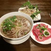 Rare Beef Eye Round Noodle Soup (Tái) · Beef broth and rice noodle. Topped with scallion, onion, cilantro and side dishes of bean sp...