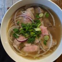 Brisket and Rare Beef Eye Round Noodle Soup (Tái nạm) · Beef broth and rice noodle. Topped with scallion, onion, cilantro and side dishes of bean sp...