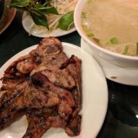 Grilled Pork Chop Noodle Soup (Phở sườn nướng) · Beef broth and rice noodle. Topped with scallion, onion, cilantro and side dishes of bean sp...