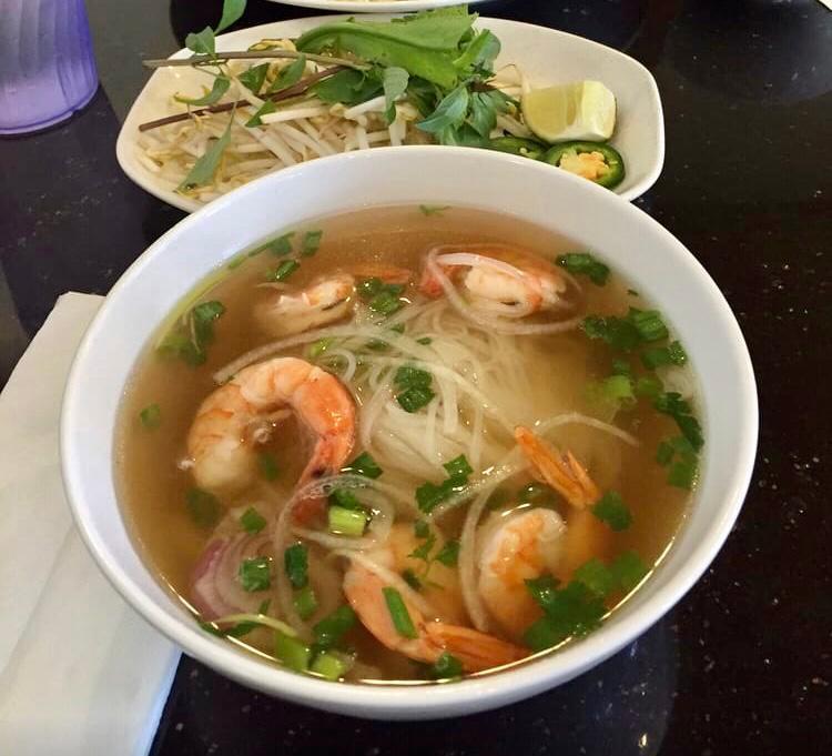 Grilled Shrimp Noodle Soup (Phở tôm nướng) · Beef broth and rice noodle. Topped with scallion, onion, cilantro and side dishes of bean sprout, basil leaves, lemon or lime, mixed Hoisin & Sriracha sauces. 
* INSTRUCTIONS:
Best way to have delicious Pho: 
- Reheat the broth until boiling. Put in the noodles for 30 seconds then remove from heat to enjoy !
