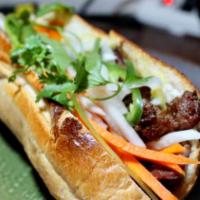 Wok Seared Flank Steak Sandwich (Bánh Mì bò xào) · Served with mayo, pate, cucumber, daikon and carrot pickles, cilantro, house special dressin...