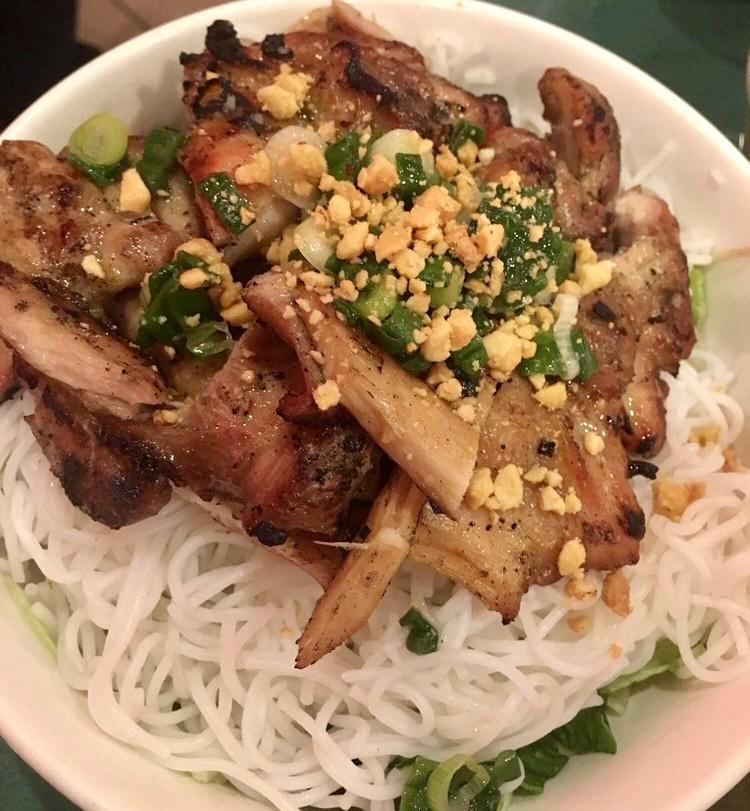 Grilled Sliced Pork over Rice Vermicelli (Bún thịt nướng) · Served with shredded lettuce, cucumber, pickles daikon and carrot, scallion oil garnish, crushed roasted peanuts and fish sauce on the side.