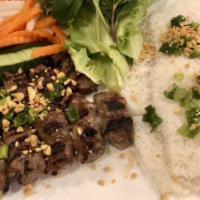 Grilled Sesame Beef over Angel Hair Rice Vermicelli (Bánh hỏi bò lụi) · Served with fresh mint, green lettuce for wrapping, cucumber, daikon & carrot pickles, scall...
