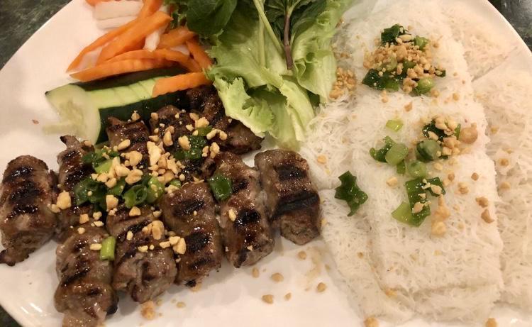 Grilled Sesame Beef over Angel Hair Rice Vermicelli (Bánh hỏi bò lụi) · Served with fresh mint, green lettuce for wrapping, cucumber, daikon & carrot pickles, scallion oil, roasted crushed peanuts, and house special dipping fish sauce.
