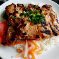 Grilled Chicken over White Rice (Cơm gà nướng) · Mild spicy BBQ dark meat chicken.
Served with daikon & carrot pickles, tomato, cucumber, sca...