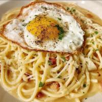 Figs Carbonara · Spaghettini, pancetta, Parmigiano and topped with a fried egg.