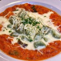 Handcrafted Basil Gnocchi · Parmigiano burro fuso, basil and roasted tomato sauce. Vegetarian.