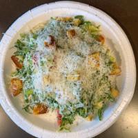Shaved Brussels Sprout and Arugula Salad · Caesar dressing, housemade croutons, parmesan and vine-ripe tomatoes.