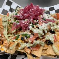 Nachos · Chips, cheese sauce, black beans, jalapenos, tomato, avocado crema, pickled red onions, coti...