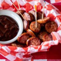 Grilled Sausage Bites · Sliced sausage grilled with a side of BBQ sauce