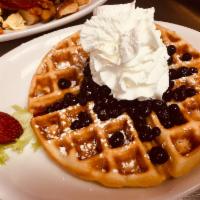Blueberry Lemon Burst Waffle · Blueberry and lemon compote with maple flavored syrup,  whipped cream, powdered sugar and bu...