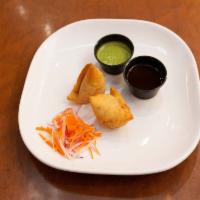 Samosa (V) · Triangular fried pastry with a savory filling of spiced vegetables. Served with mint and tam...
