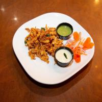 Onion pakoda (V, G) · Fried fritters made of chickpea-battered onion strings