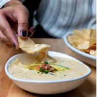 Chips and Queso  · Queso blanco with roasted poblanos, pico de gallo, avocado and fresh corn chips. Vegetarian. 