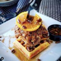 Chicken and Waffle  · Buttermilk battered fried chicken, sweet potato waffle, pecan bourbon syrup and orange slice.