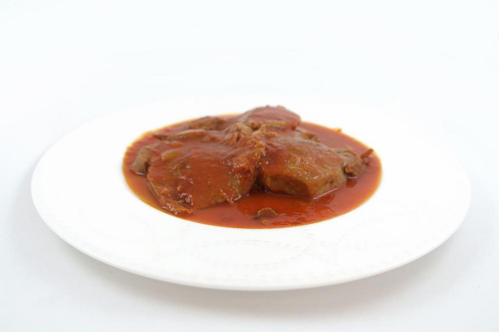 8. Lengua Guisada · Stewed beef tongue in tomato sauce with 2 sides and 2 tortillas.
