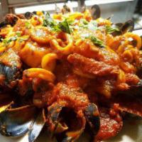 Seafood Fra Diavolo · Over linguine. Shrimp, scallops, calamari and mussels in a plum tomato sauce (sweet, medium ...