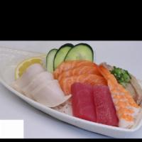 Chirashi Bowl Sushi Combo · 15 pieces of fish chef's choice arrange over a bowl of sushi rice.
