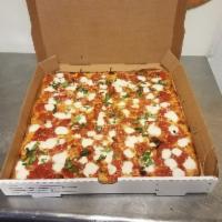 Brooklyn Gourmet Pizza · Thin crust, square with chunks of tomato, fresh mozzarella, basil olive oil, and Parmesan ch...