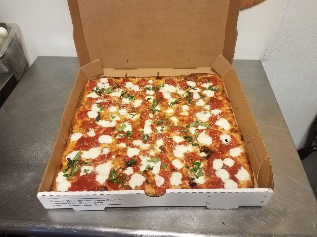 Brooklyn Gourmet Pizza · Thin crust, square with chunks of tomato, fresh mozzarella, basil olive oil, and Parmesan cheese.