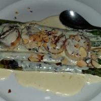 Pan-Seared Scallops · Served with grilled asparagus and toasted almonds in a champagne cream sauce.