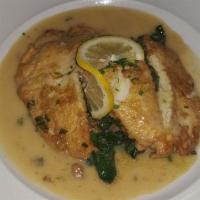 Tilapia Francesca · Tilapia dipped in egg, with lemon butter white wine, and spinach.