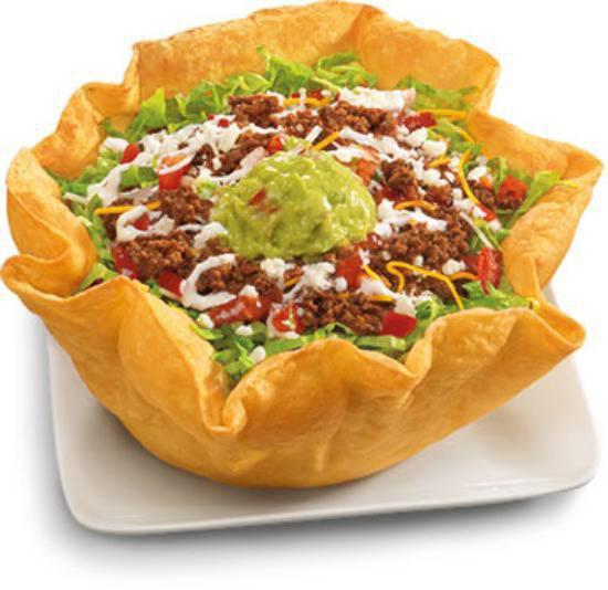 Beef Taco Salad · Seasoned ground beef with pinto beans, shredded lettuce, fresh salsa, four-cheese blend and hot sauce garnished with guacamole, pico de gallo, sour cream and cotija cheese in a crispy flour tortilla bowl.