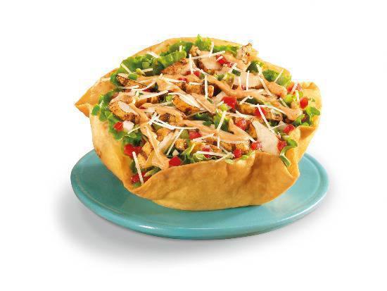 Chicken Taco Salad · Charbroiled chicken with pinto beans, shredded lettuce, fresh salsa, four-cheese blend and hot sauce garnished with guacamole, pico de gallo, sour cream and cotija cheese in a crispy flour tortilla bowl.