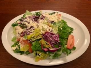 Greek Salad · Crisp lettuce, tomatoes, red onions, red cabbage, pepperoncini, black olives and feta cheese.