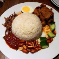 70. Nasi Lemak Dish · Coconut rice with vegetable pickled, anchovy, curry chicken, hard-boiled egg, peanut, and se...