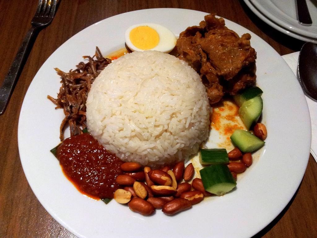 70. Nasi Lemak Dish · Coconut rice with vegetable pickled, anchovy, curry chicken, hard-boiled egg, peanut, and sesame seed. Hot and spicy.