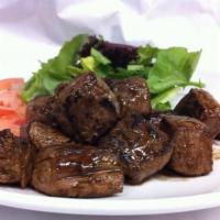 43. Bo Luc Lac · Stir fried steak cubes served with tomato and baby green salad.