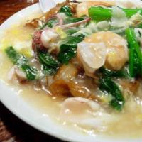 89. Scramble Egg Chow Fun · Flat rice noodle in a light brown egg sauce topped and veg. Hot and spicy.