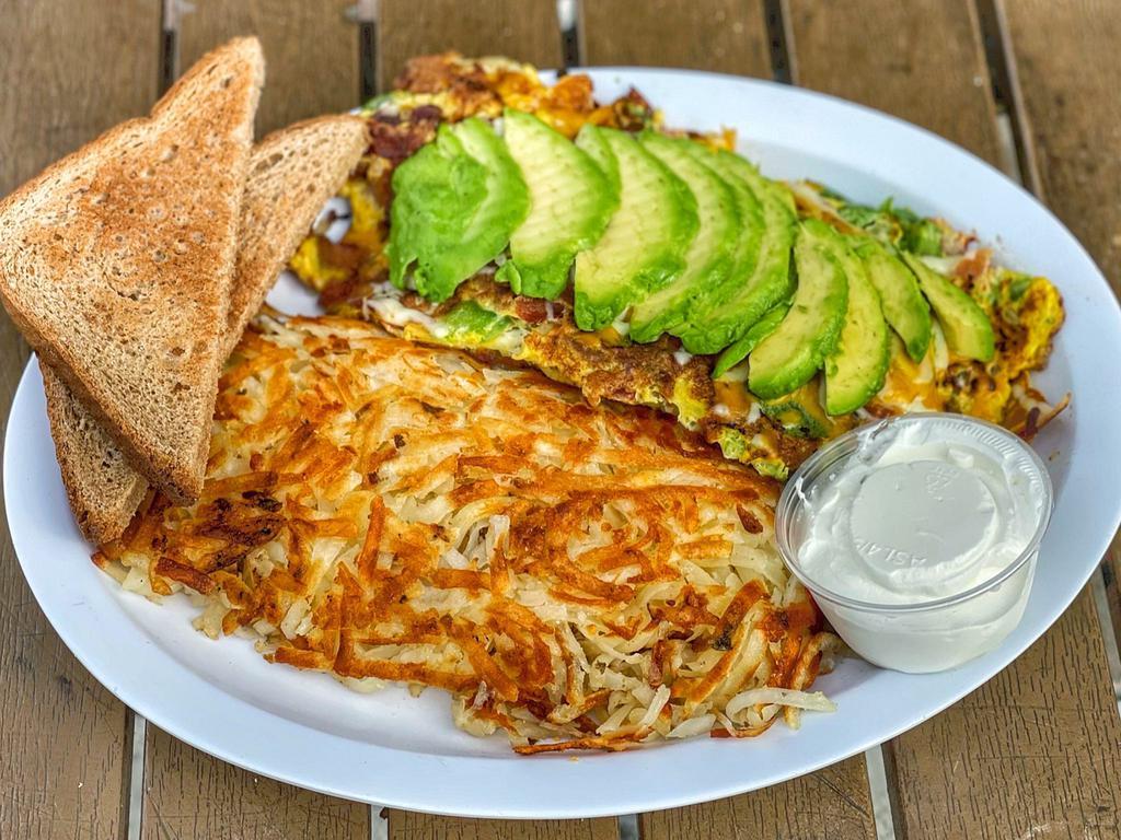 Ted's Omelette · Bacon, mushroom, onions, bell pepper, tomato, topped with cheese, sour cream, and avocado.  Served with hash browns or home fries, toast & jelly.