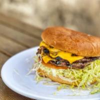 Double Cheese Burger · Dressed with 1000 Island, lettuce, onions, tomato, and pickle on a sesame seed bun.