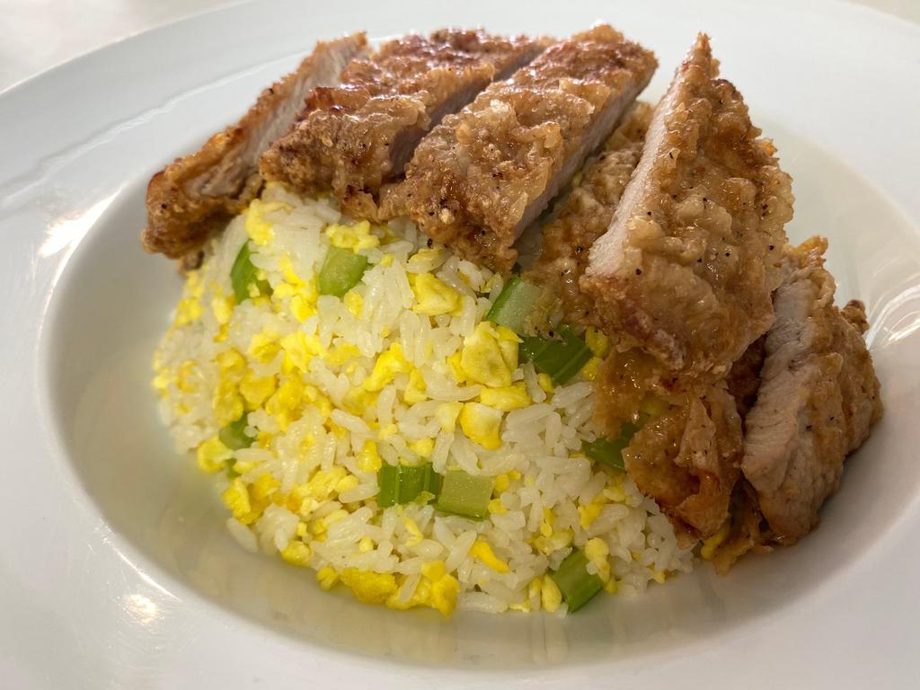 Taiwanese Pork Chop Fried Rice 台灣排骨黃金蛋炒飯 · Our signature egg and celery fried rice, topped with a lightly fried pork chop. Add our famous tender stewed pork belly sauce for a unique twist on this Taiwanese classic.