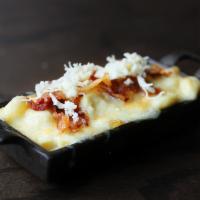 Bacon Mac and Cheese · Bacon-Infused Queso sauce tossed with cavatappi pasta and topped with a crust of gooey white...
