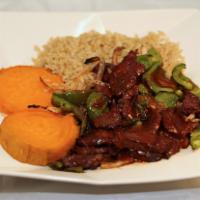 58. Zesty Steak · Zesty lean steak with onions and peppers over sweet potatoes and brown rice. Served BBQ sauce.