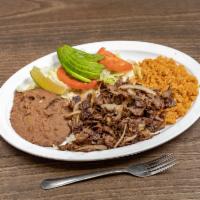 13. Fajitas Plate · Beef or chicken with avocado and pico de gallo. Comes with rice, beans, salad, and two homem...