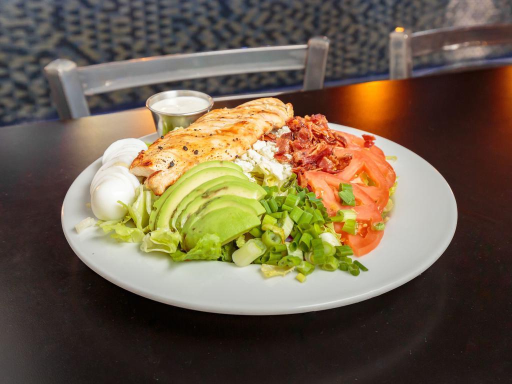 Chicken Cobb Salad  · Greens garnished with juicy grilled chicken, egg, crispy bacon, tomatoes, onions, green onions, avocado and bleu cheese.