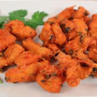 Chicken Pakoras ·  Deep fried chicken tenders served with mango and mint sauces.