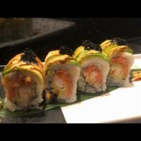 23. Ocean Roll · Inside: Spicy tuna and shrimp tempura. Outside: Super white tuna, avocado and black tobiko. 