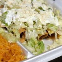 Flautas · 4 chicken flautas topped with lettuce, cheese and sour cream. Served with rice and beans.
