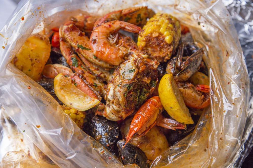 Shaking Boil · Seafood poached in a blend of herbs and spices, tossed with one of our signature sauces, and served in a bag to preserve the warmth.