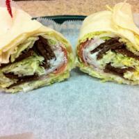 #9. Gyro Wrap · Strips of grilled beef, lettuce, tomatoes, red onions and tzatziki sauce in a flour tortilla.